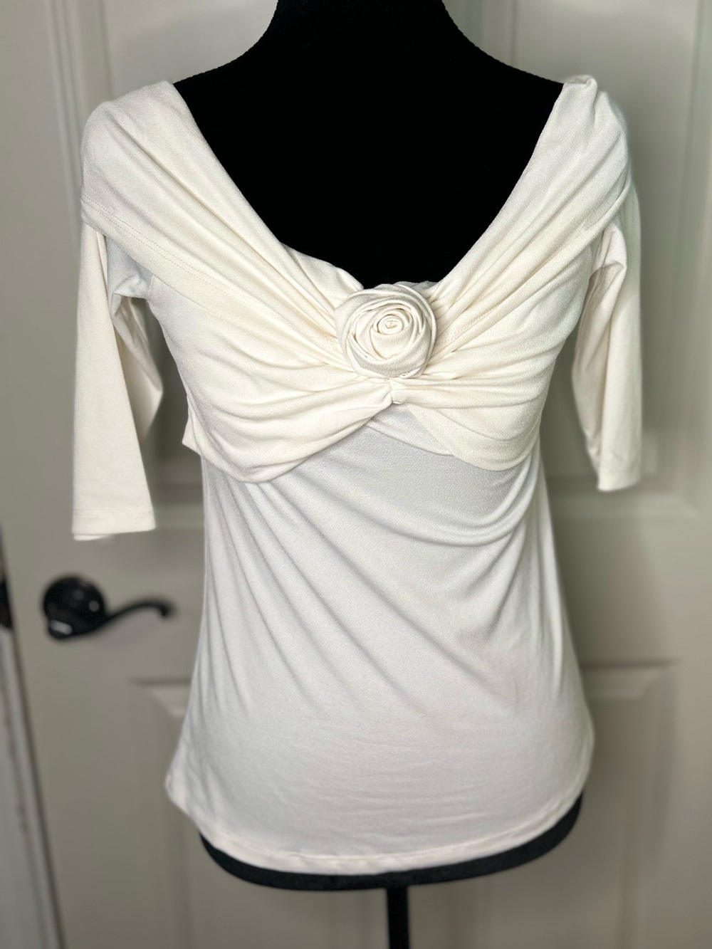 Cable & Gauge off-the-shoulder white top with a rosette detail twisted front.